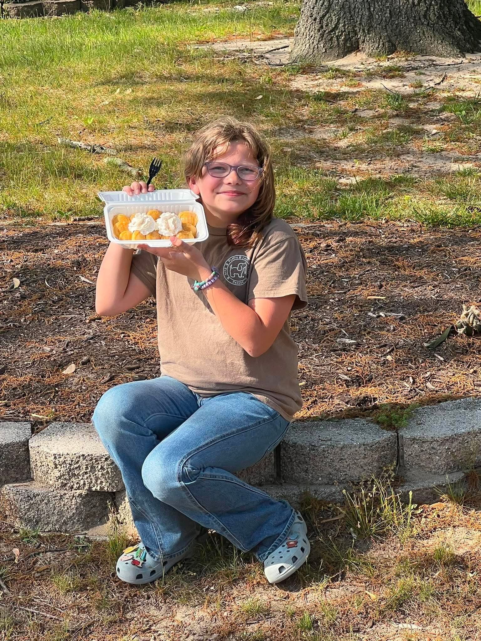 A child holding a plate of mini pancakes at a Pancake Peeps event