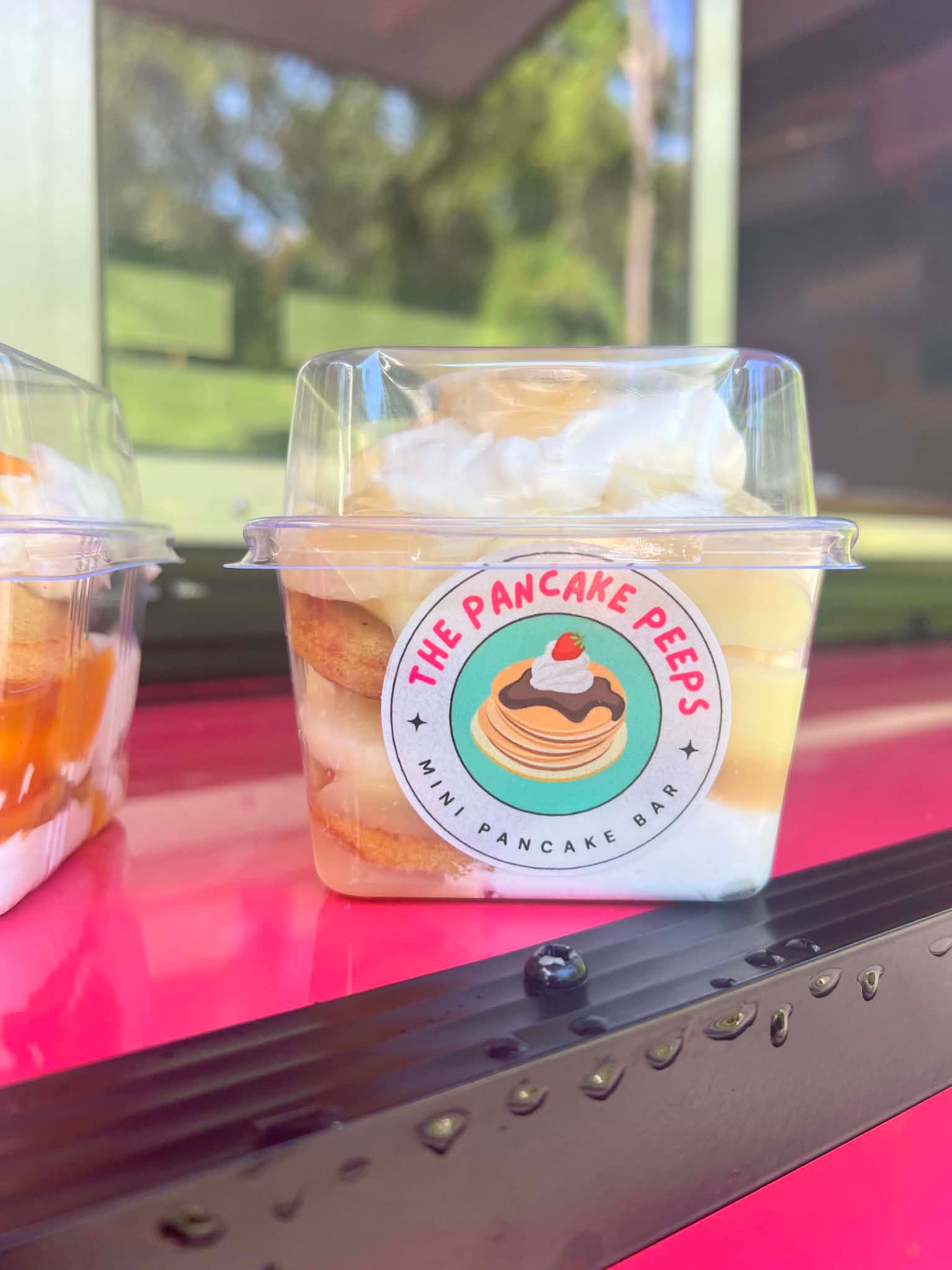 OG mini pancakes with whipped cream in a cup