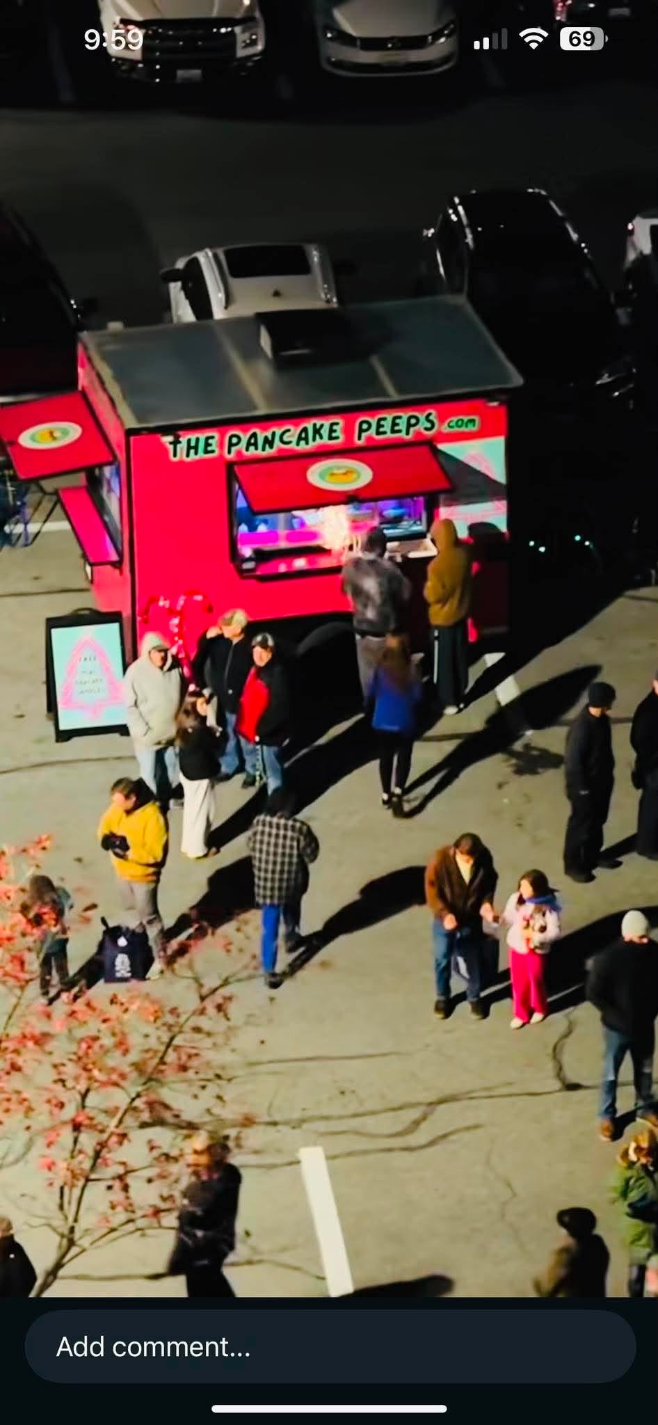 The hot pink PEEPSMOBILE pancake trailer at a night event with a crowd of guests