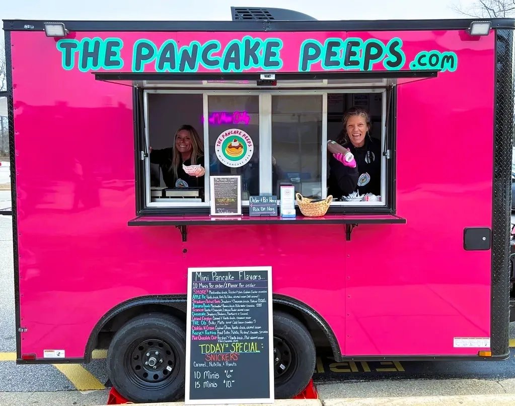Lynda and Lauren serving from the PEEPSMOBILE pink pancake trailer window